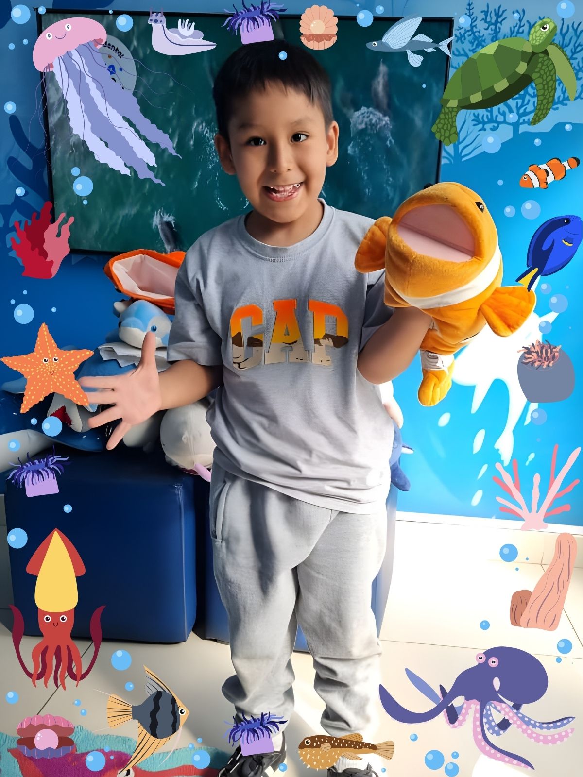 Niña con sombrero de pez y tiburón de peluche en consultorio odontopediátrico marino Lima